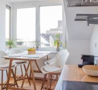 A bright kitchen in a 3-room apartment with a bar table and a view of the city.