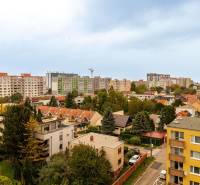 View of Hraničná Street in Bratislava - Ružinov with apartment buildings and greenery.