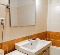 A bathroom with a mirror and a sink in a 2-room apartment.