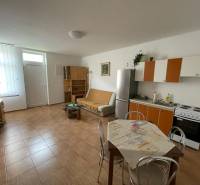 Interior of a family house with a kitchenette and a wooden decor floor.