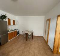 Kitchen in a family house with tiles and a dining table.