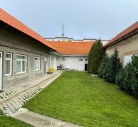 A family house on M. A. Beňovského Street in Vrbové with a lawn and a paved terrace.