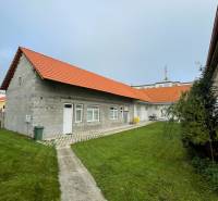 A family house on M. A. Beňovského Street in Vrbové, with a red roof and a lawn.