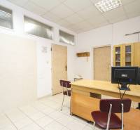 Office with a desk, chair, computer, and cabinet on a light ceramic floor.