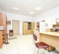 Offices with white walls, wooden furniture, and ceramic flooring.