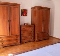 Wooden furniture with wood-decor flooring in a 2-room apartment, elegant composition.