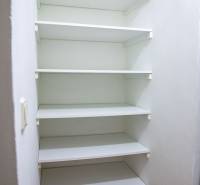 White multi-level storage shelf in a 2-room apartment, floor with wood decor.