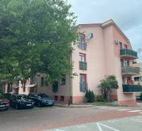 Apartment building on Mierová Street in Bratislava-Ružinov with parking spaces in the front.