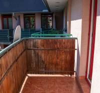 The balcony of the apartment on Mierová Street in Bratislava - Prievoz, with wooden railing and tiles.