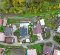 Aerial view of a family house in the village of Domaniža with a swimming pool and garden.