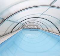 Covered swimming pool in a family house in Domaniža with an arched structure.