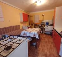 A kitchen in a family house with a gas stove and a wooden decor floor.