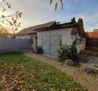 A family house in Dlhá Ves with a courtyard, lawn area, and garage surrounded by a fence.