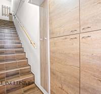 Stairs with a wooden decor floor leading to built-in wardrobes in a 3-room apartment.
