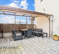 In Gabčíkovo, sitting on the terrace of a 3-room apartment with garden furniture on the tiles.