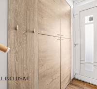 Entrance hallway with a built-in wardrobe and white doors in a 3-room apartment.
