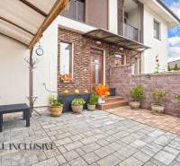 Terrace of a 3-room apartment in Gabčíkovo with tiles and flower pots, along the brick cladding.