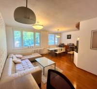 Living room in a 3-room apartment with a sofa, table, and dining area.