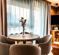Dining area in a 2-room apartment with a wooden decor floor and a view from the window.