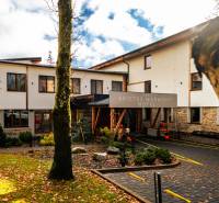 The hotel building with trees and falling leaves in Štrba on Lúčna Street.