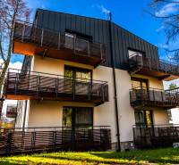 Apartment building on Lúčna Street in Štrba with modern balconies and surrounding greenery.