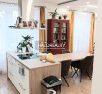 Modern kitchen in a 3-room apartment with an island and flooring with a wood decor.