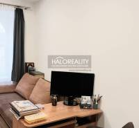 Living room with a sofa, a table, and a wooden decor floor in a 3-room apartment.