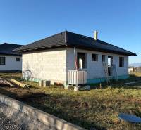 Unfinished family house in Vyšná Šebastová in Prešov with a black roof and construction material.