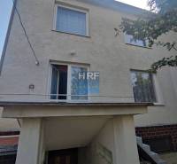 Family house in Radošovce in Vieska with an external staircase and white facade.