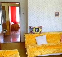 Living room in a family house with colorful blankets and upholstery on the couches.
