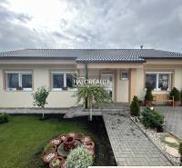 A family house in Malinová with a landscaped garden, lawn, and garden decorations.