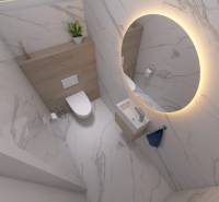 A bathroom with a round mirror, sanitary ware, and decorative tiles in a family house.
