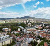 Aerial view of Nitra from Ivana Braunera Street with a view of family houses and the landscape.
