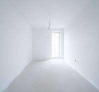An empty interior with white walls and open doors in a family house.