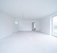 A spacious bright room in a family house with large windows.