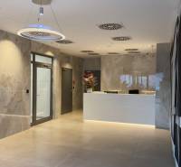 Lobby with mailboxes and reception. Lights and flowers on the counters.