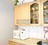 Kitchen in a 3-room apartment with cabinets, a microwave, and a sink.