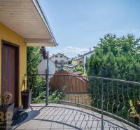 A balcony with a view of the gardens in guesthouses, Poprad, Hotels and guesthouses. Decorative flower pots.