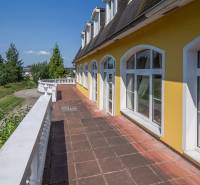 Yellow building with attic windows and a terrace in Hotels and Guesthouses in Poprad.