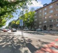 Vajnorská Street, Studio apartment in Bratislava - Nové Mesto, passing cars and a cyclist.