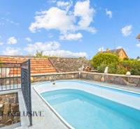 Swimming pool and stone fence at the family house on Kúpeľná Street in Dunajská Streda.