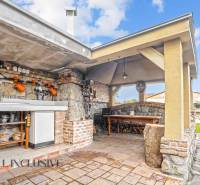 The exterior of a family house on Kúpeľná Street in Dunajská Streda, outdoor kitchen with seating area.
