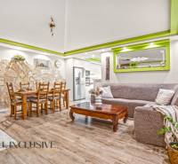 A living room in a family house with a stone wall and a wooden decor floor.