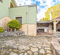 A family house on Kúpeľná Street in Dunajská Streda with stone paving and a garden kitchen.