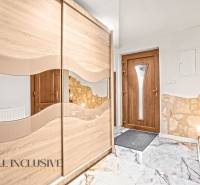 Entrance hall in a family house with a sliding wardrobe and doors in wood decor.