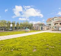 The garden of a family house on Kúpeľná Street in Dunajská Streda with a well-maintained lawn and trees.
