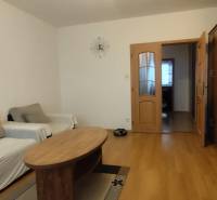 Living room with wood-patterned flooring, a coffee table, and two sofas, 3-room apartment.