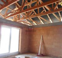 Under-construction interior of a family house on Nové Mesto nad Váhom street with a wooden roof structure.