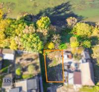 Aerial view of a residential plot in Jahodná, surrounded by greenery near the water.