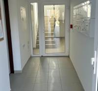 Entrance hallway with white doors and mailboxes in a 3-room apartment.
